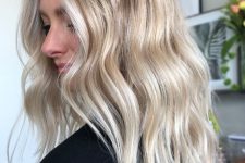 a chic bright blonde balayage with a bit darker root but not too much looks very nice, cute and lovely, beach-style