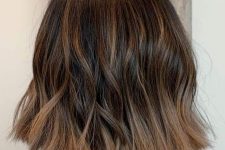 a long brunette bob with caramel balayage and waves is a chic and stylish idea to try right now