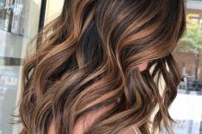 beautiful long dark brown hair with rich caramel highlights and waves for a more eye-catchy and cool look