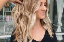beautiful long hair with honey blonde balayage and bleached money piece, waves and volume is a lovely and chic idea
