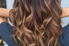 black hair with caramel and auburn balayage that brings much texture and dimension to the hairstyle will make you stand out