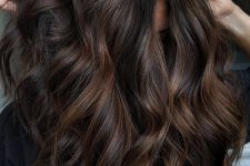 dark brunette hair with caramel balayage to give it dimension, with waves and volume is a gorgeous idea