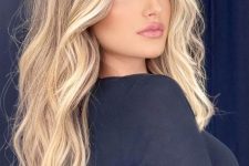 fab long hair with blonde balayage and bleached money piece, with volume and waves looks absolutely stunning