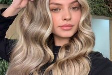 gorgeous long hair with blonde balayage and waves looks amazing, and face-framing locks accent the face features