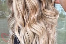 gorgeous long volumetric hair with warm and honey blonde balayage and waves looks incredible, this is pure beauty