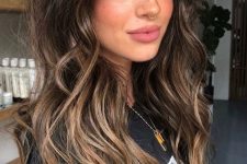 long dark brunette hair with bronde balayage and waves plus a lot of volume is a chic and lovely idea