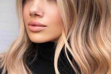 long hair with blonde balayage, waves and volume is a chic and stylish idea to rock, bleached money piece accents the face