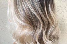 long volumetric hair with blonde balayage and a shadow root is amazing, it looks bold and chic