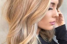 lovely honey blonde beach hair with a darker root, with balayage and babylights and just a bit of texture and waves