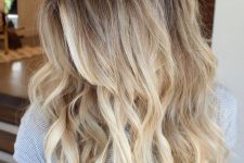 lovely long hair with bleached blonde balayage and waves, shadow root and volume is a chic and stylish idea to rock