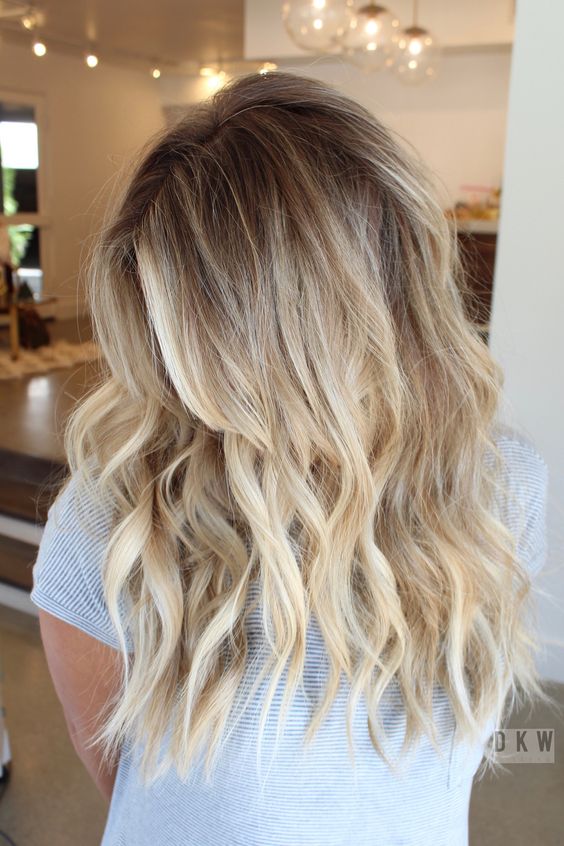 lovely long hair with bleached blonde balayage and waves, shadow root and volume is a chic and stylish idea to rock