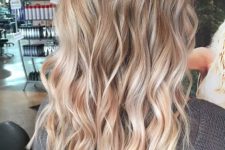 lovely long hair with honey blonde and golden blonde balayage, waves and a darker root is a chic and cool idea