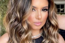 lovely medium-length dark brunette hair with golden blonde balayage, with waves and volume is a fantastic idea
