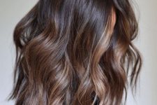 medium-length dark brunette hair with caramel balayage and waves is a lovely idea, and highlights bring dimension