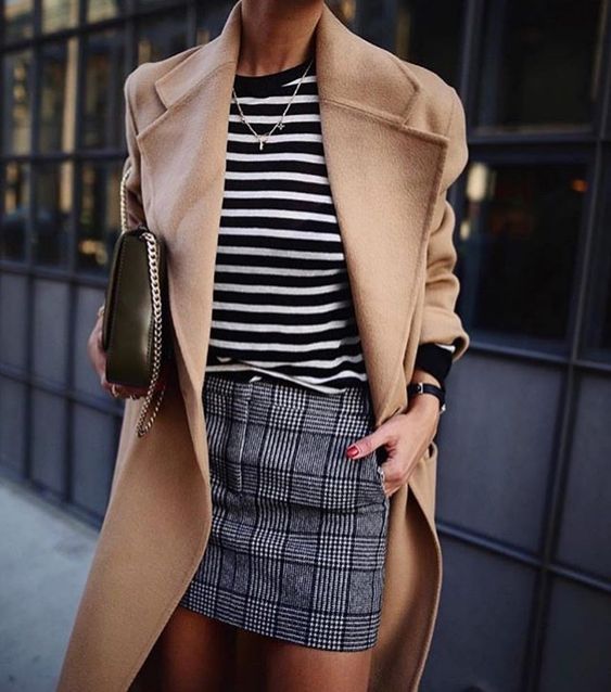 a checked mini skirt, a black and white striped top, a camel coat and a black bag