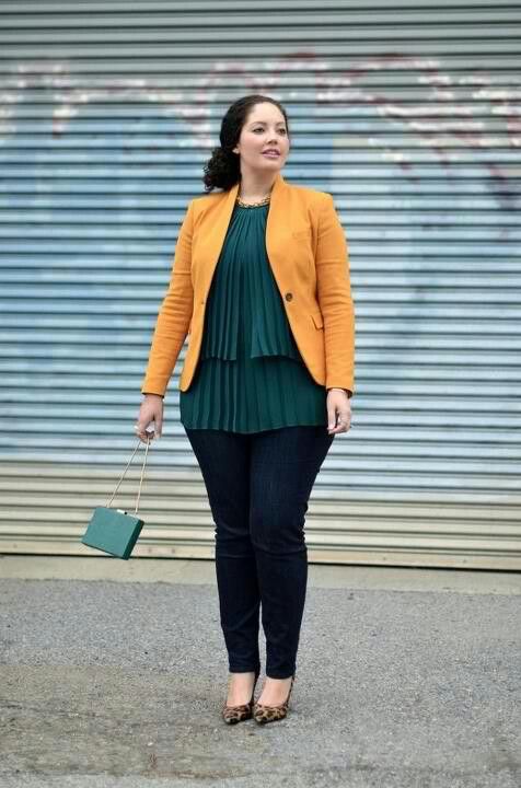 a colorful look with navy skinnies, a dark green pleated layered top, a yellow jacket and a bag