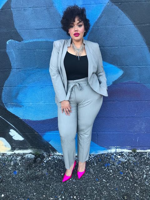 a chic light grey suit with a black top, a statement necklace and hot pink heels for a bold look