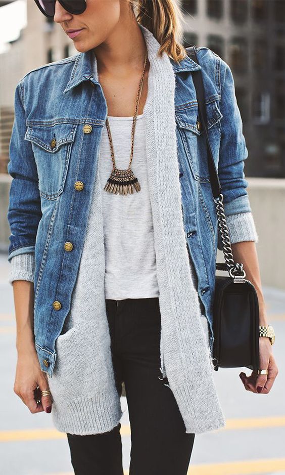 a grey tee, a grey cardigan, a denim jacket over it and a statement necklace