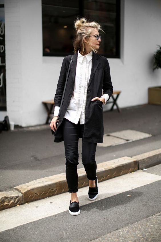 black skinnies, a white long shirt, a black blazer and slip-ons for a casual work look
