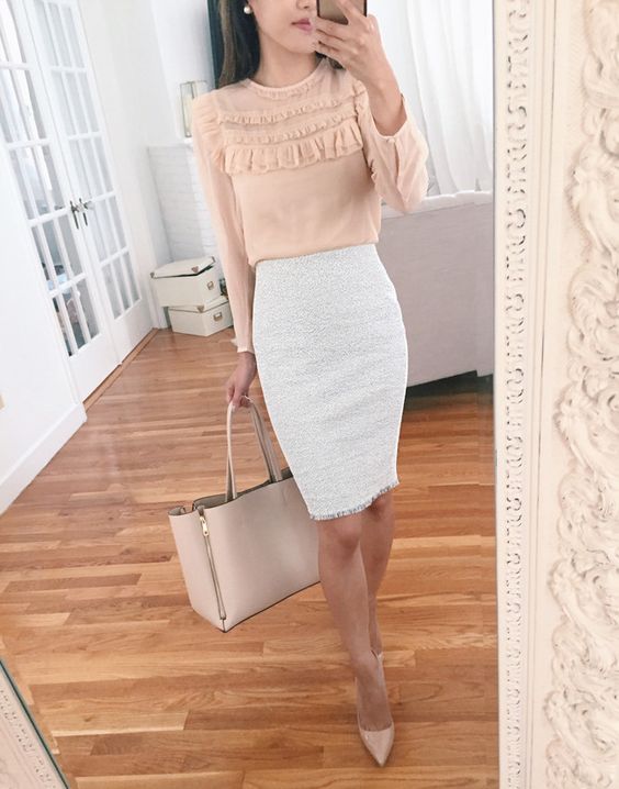 a blush ruffled blouse, a creamy knee pencil skirt, nude shoes and a neutral bag