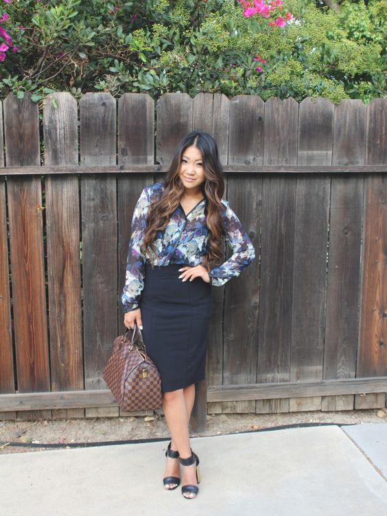 a black pencil skirt, a bold floral blouse, black ankle strap shoes and a brown bag