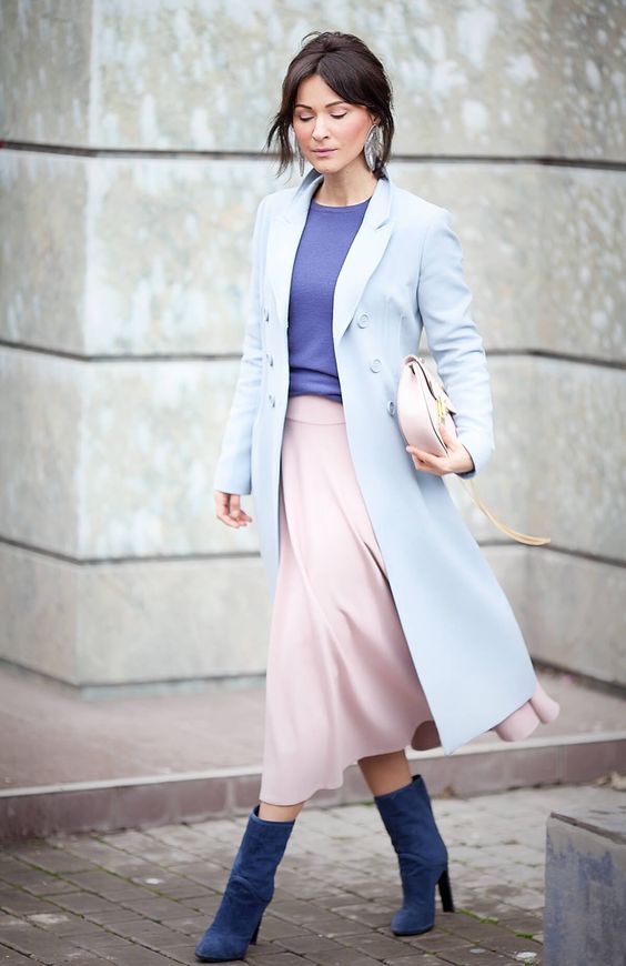 a powder blue coat, an ultra-violet top, a pink midi skirt, blue boots and a blush bag
