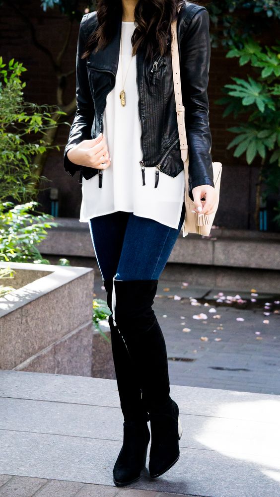 blue skinnies, black suede tall boots, a white pullover and a black leather jacket