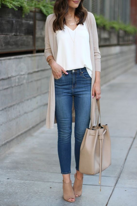 blue jeans, a white top, a tan long cardigan, tan peep toe booties and a matching bag