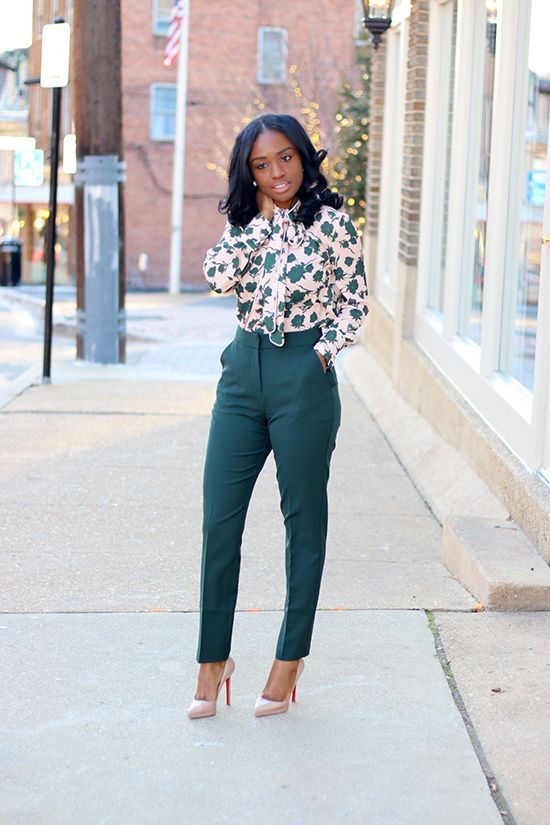 emerald pants, a floral print blouse in the same shades and nude heels