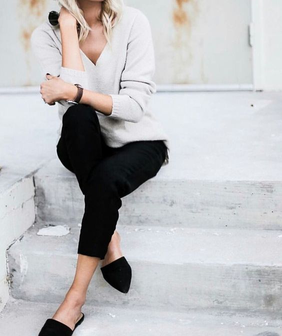 black jeans, black flats, a neutral sweater for a simple office-ready look