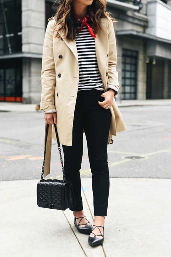 blue skinnies, a black and white striped top, black lacing up shoes, a neutral trench and a black bag