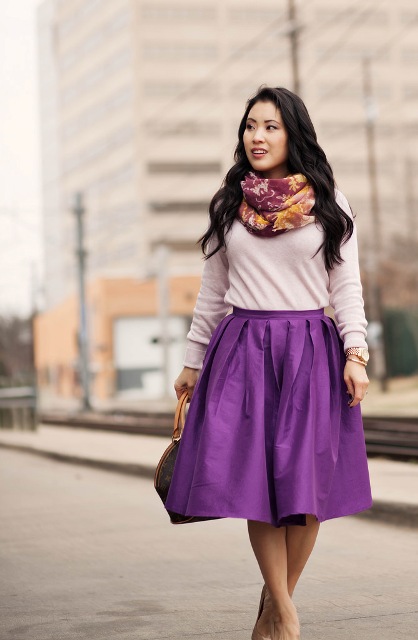 With beige shirt, purple skirt and bag