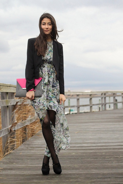 With black blazer, platform shoes and gray and pink clutch