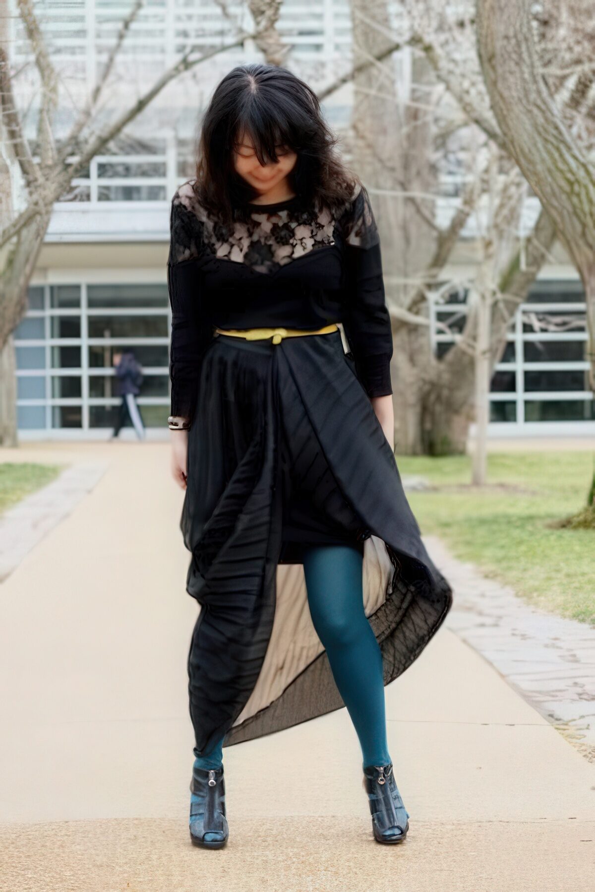 With black lace shirt, yellow belt, colored tights and ankle boots