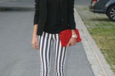 With black shirt, black blazer, red clutch and pumps