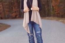 With black shirt, distressed jeans and brown suede mid calf boots