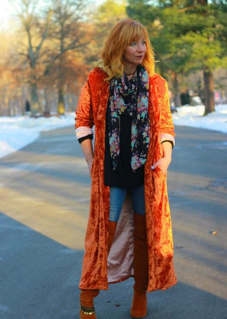 With black shirt, jeans, over the knee boots and orange velvet maxi coat