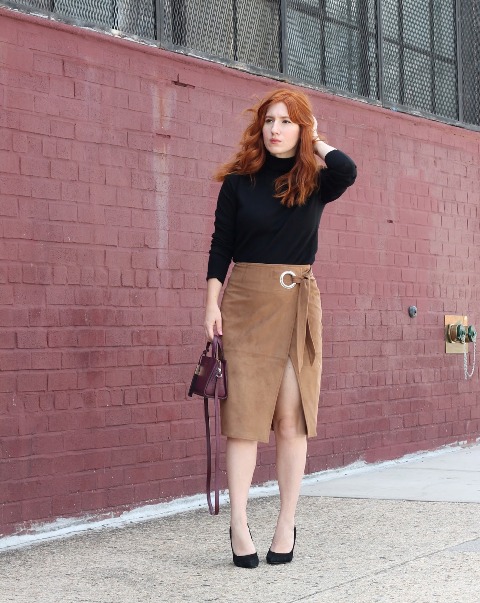 With black turtleneck, black pumps and purple small bag