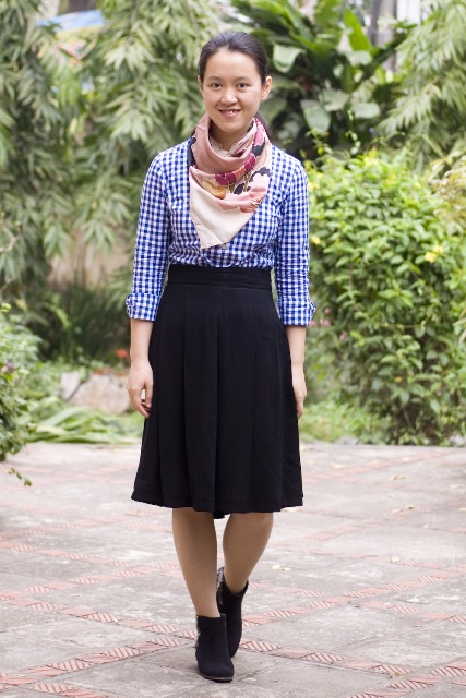 With checked shirt, knee length skirt and ankle boots