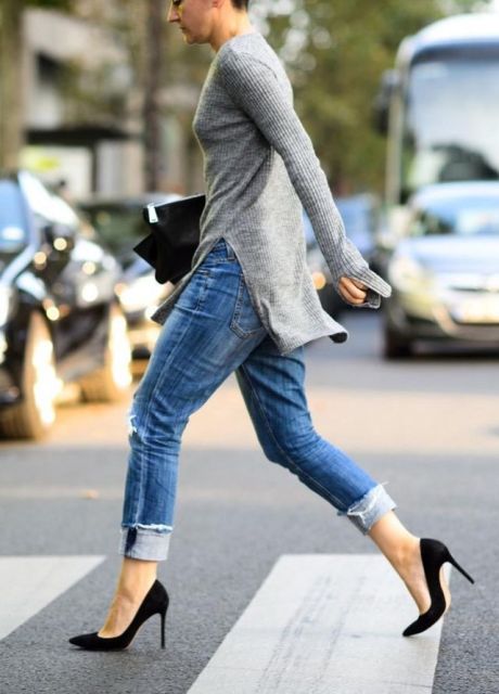 With cuffed jeans, black pumps and clutch