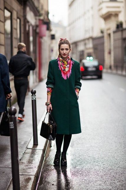 With green coat, platform boots and small bag