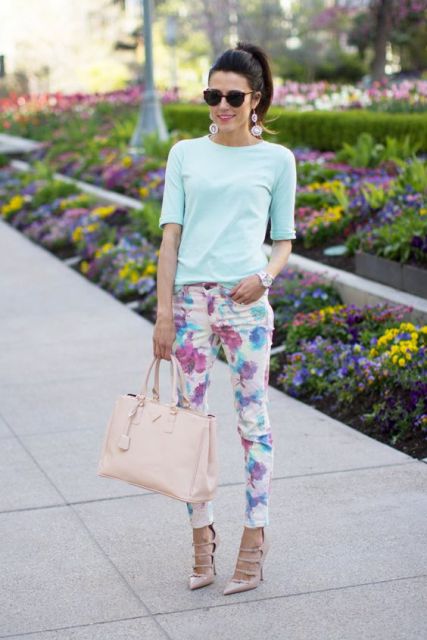 With light blue shirt, floral pants and bag