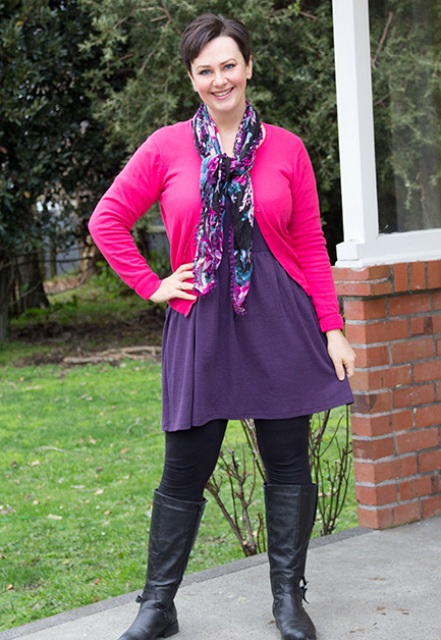 With purple dress, black tights, black high boots and pink cardigan