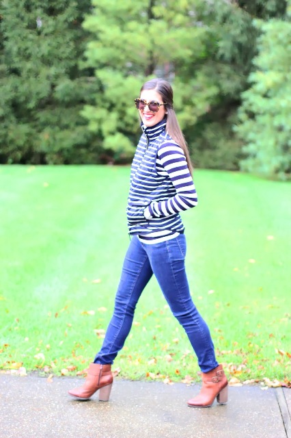 With striped shirt, skinny jeans and brown ankle boots