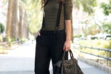 With striped shirt, sneakers and black leather bag