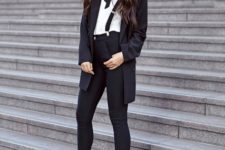 With white button down shirt, black pumps, long blazer and wide brim hat