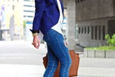 With white shirt, cobalt blue jacket, skinny jeans and brown bag