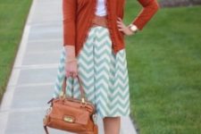 With white t-shirt, orange cardigan, turquoise shoes and brown bag