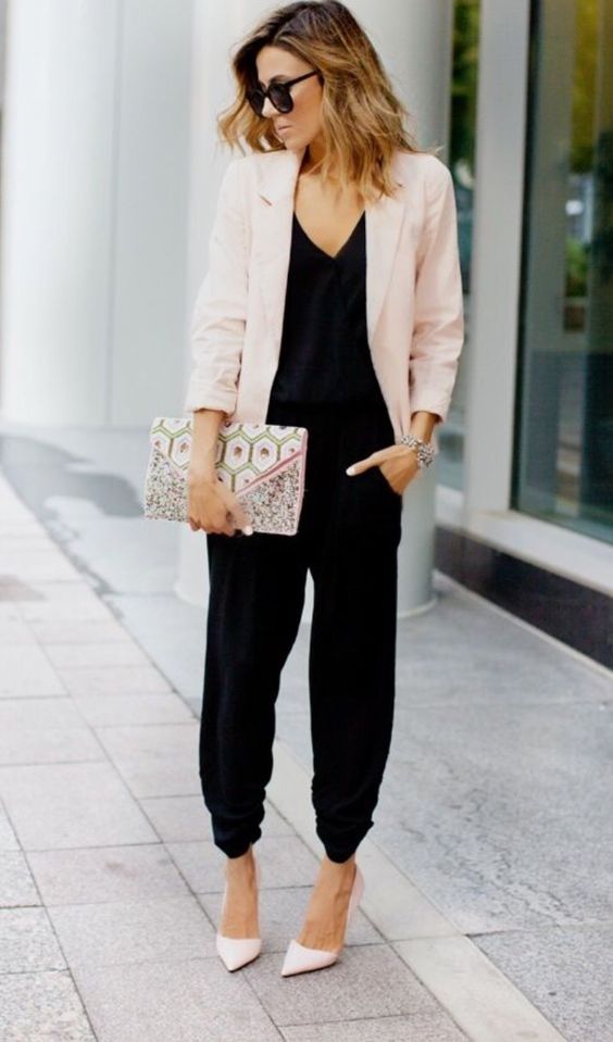 a black jumpsuit, a blush blazer, blush shoes and a printed clutch for a chic contrasting look