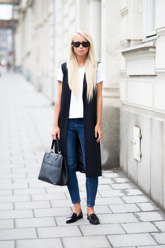 blue skinnies, a white tee, black long vest and black flats for a business casual look